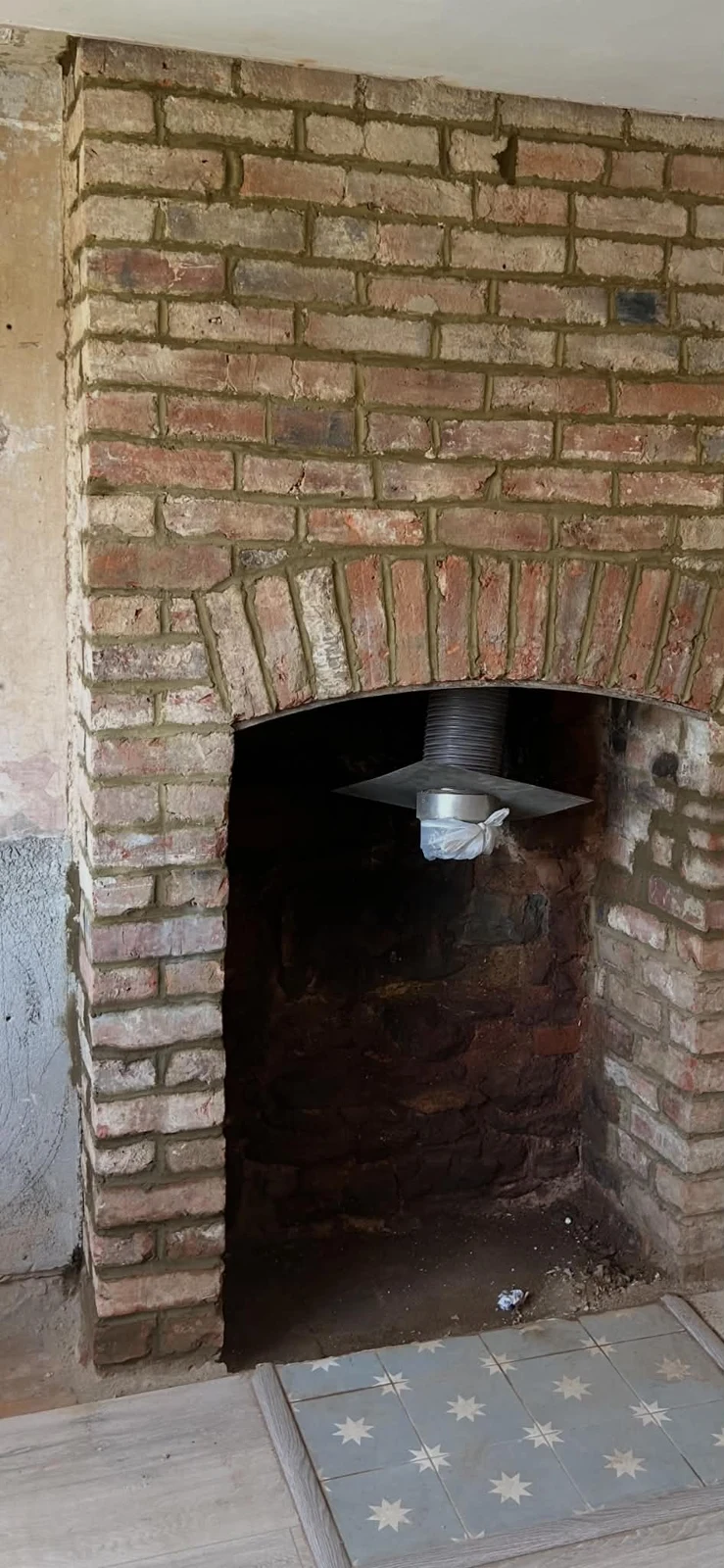 Restored exposed brick fireplace arch