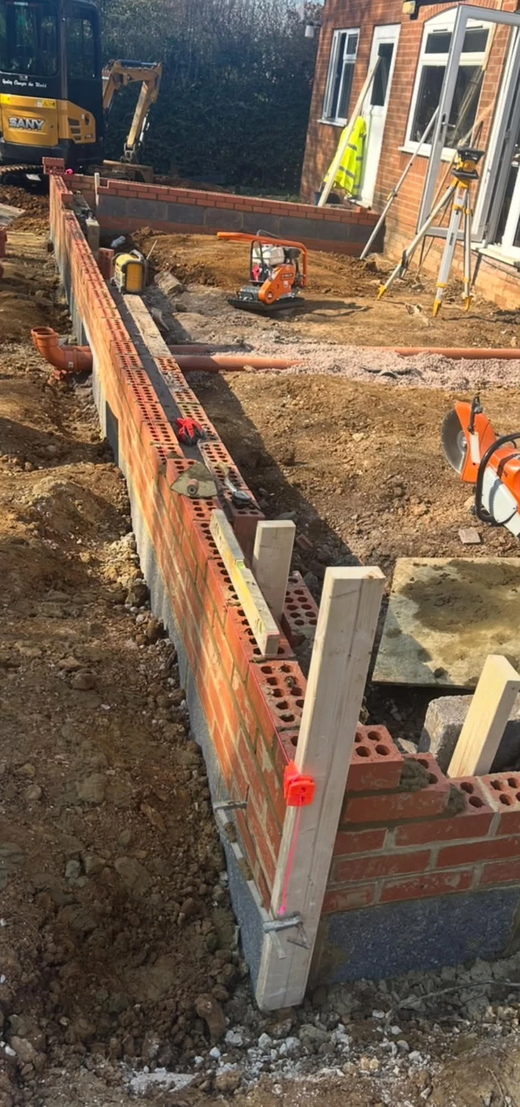 Early courses of extension brickwork on site