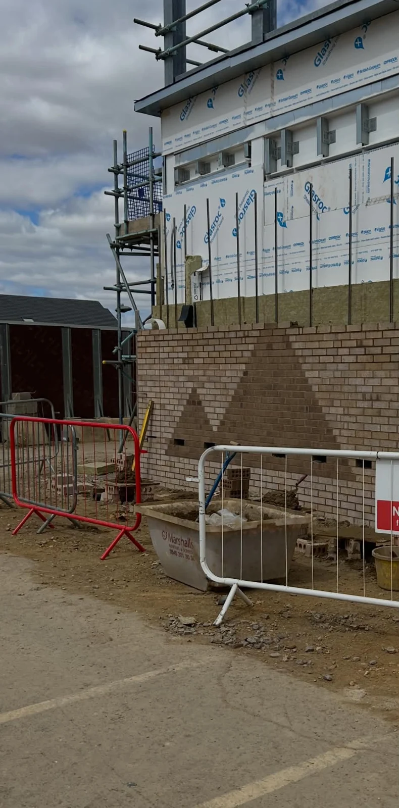 External brickwork under construction with scaffolding